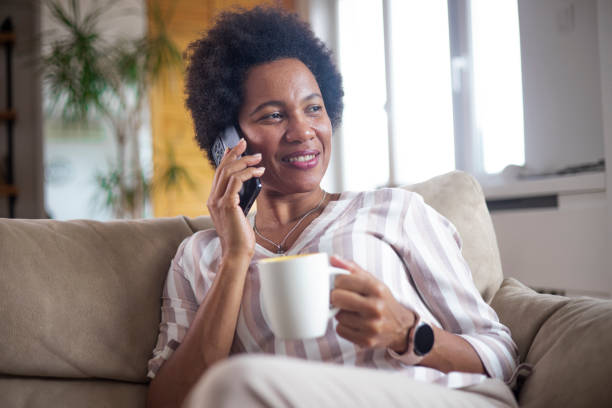 istock Happy black businesswoman using a smartphone 1451330471
