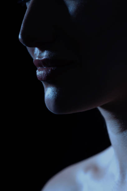 istock Part beautiful woman face silhouette covered in shadow 1451337641