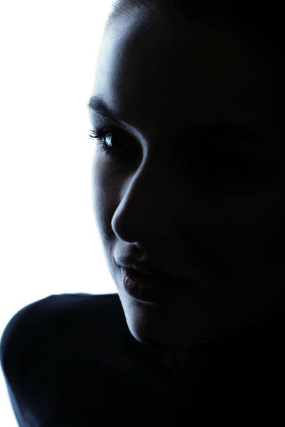 istock Part beautiful woman face silhouette covered in shadow 1451337648