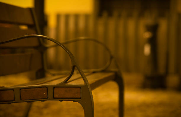 Wooden bench on park at night