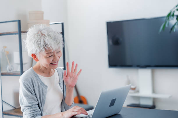 istock A smiling senior woman making a video call 1451346012
