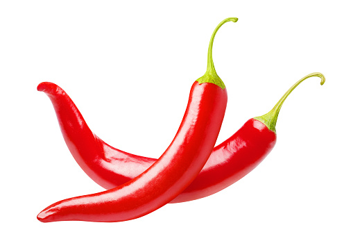 Two red chili peppers, isolated on white background