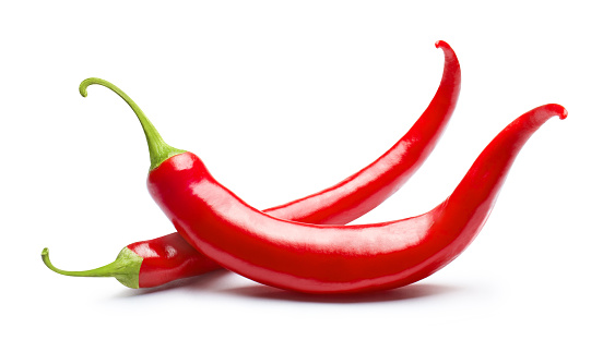 Two red chili peppers, isolated on white background