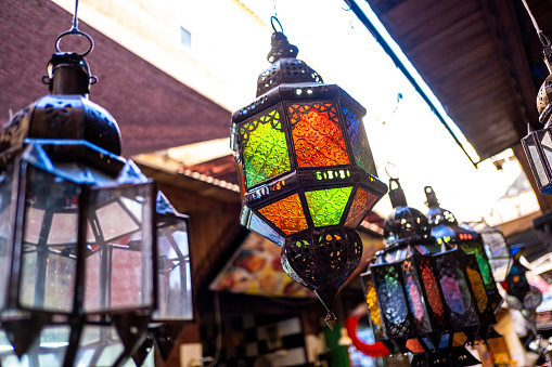 Moroccan lamp displayed in a medina store. The typical Moroccan lamps are decorated with multiple ornaments, engravings and colored crystals.