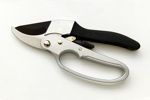 Pocket folding knife isolate on white background. Compact metal sharp knife with a folding blade.