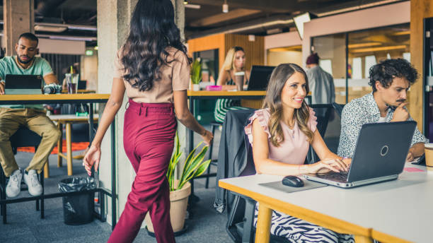 istock Indian woman passing by the office tables 1451352771