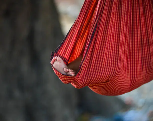 A child sleeping on cot at the village in Mandalay, Myanmar.