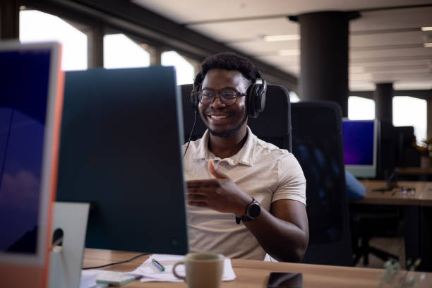 istock Happy black programmer having a video call over PC in the office. 1451360319