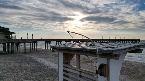 istock Beautiful sunset over a pier in the sea. 1451364559