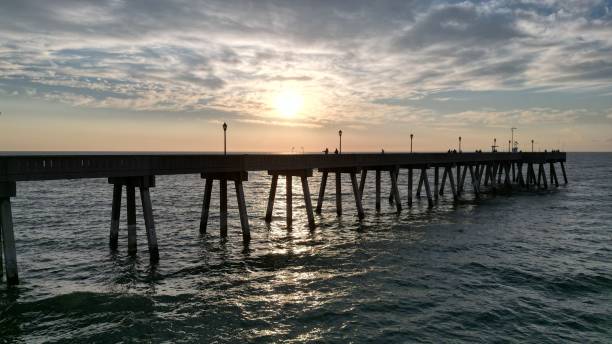 istock Beautiful sunset over a pier in the sea. 1451364561