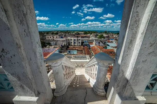 A high angle shot of white stairs leading down to Cienfuegos city in Cuba