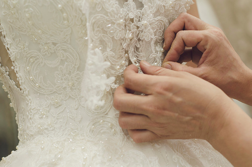 fashion designer sewing wedding dresses stock photo