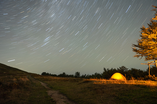 Tourist tent on a hill overlooking the night sky. High quality photo