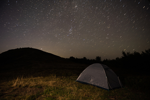 Tourist tent on a hill overlooking the night sky. High quality photo