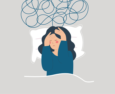 Tired woman lying on bed and has difficulty to sleep at night due to headache. Sad girl suffers from insomnia, nightmares and negative tangled thoughts. Concept of Mental health and sleep disorder.