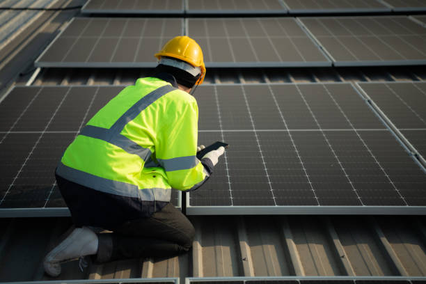 istock Technicians provide quarterly solar cell maintenance services on the factory roof 1451377896