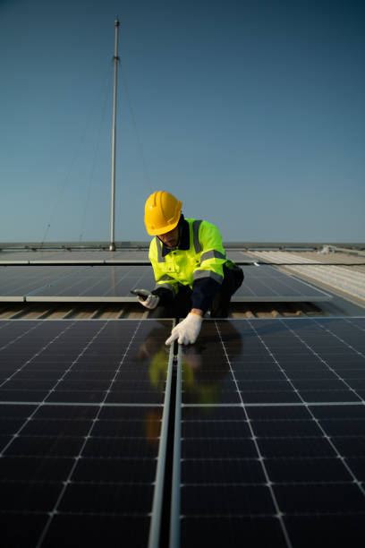 istock Technicians provide quarterly solar cell maintenance services on the factory roof 1451377919