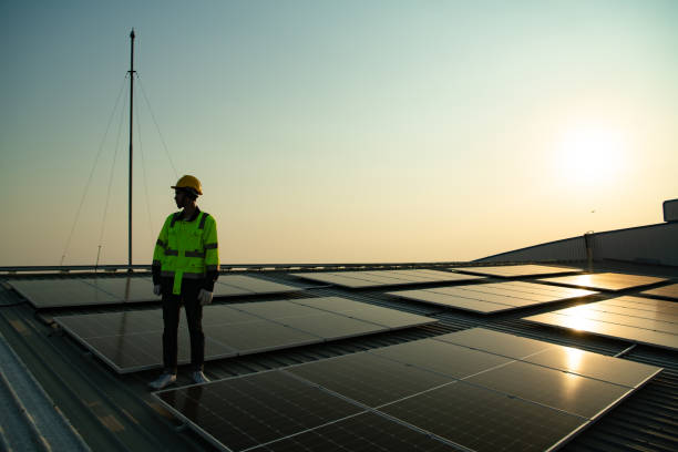 istock Technicians provide quarterly solar cell maintenance services on the factory roof 1451377970