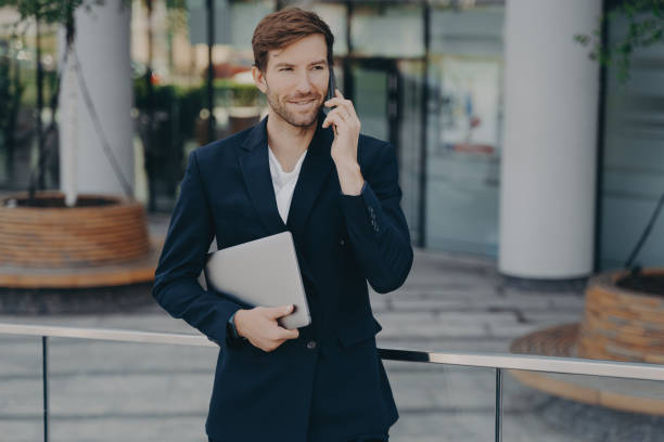 istock Executive manager inn formal clothes has mobile talk outdoors 1451381573