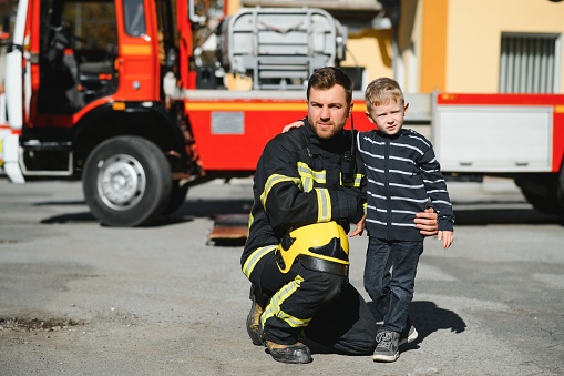 Protect people from dangerous with brave heart.Hero in fireman with uniform safe children from burn smoke.