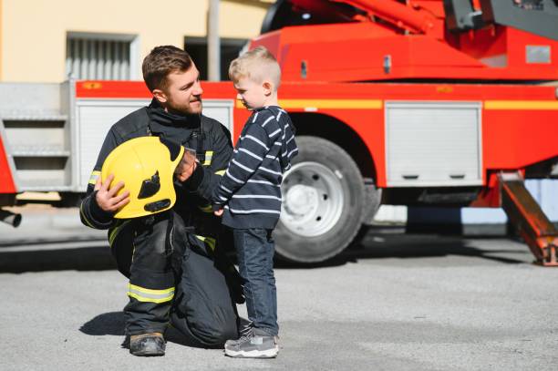 istock Portrait of a firefighter standing in front of a fire engine 1451388115