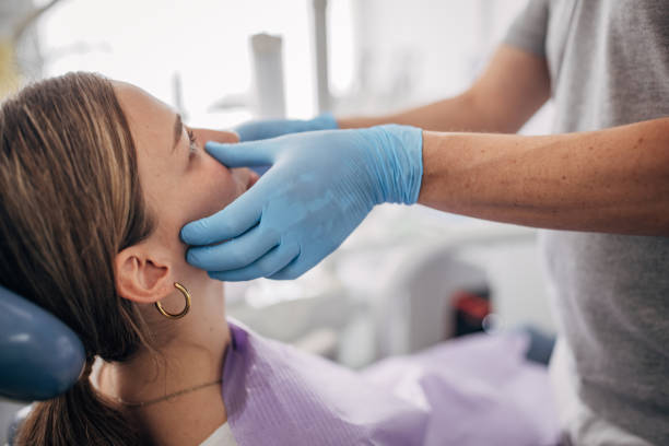 istock Young woman at the dentist 1451388349