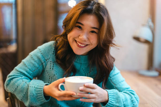 istock Young woman drinking coffee in cafe 1451390862