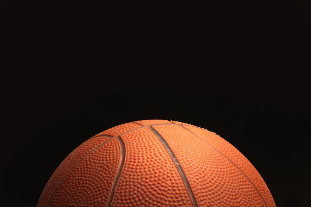 istock A basketball ball on a black background with copy space 1451394987
