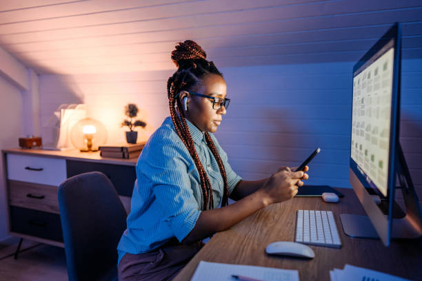 istock Businesswoman text messaging while working late at her home office 1451397964