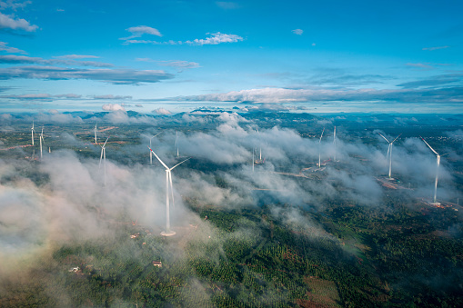 Drone view wind turbine in a foggy morning on Ea'hleo, Dak Lak province, central highland Vietnam