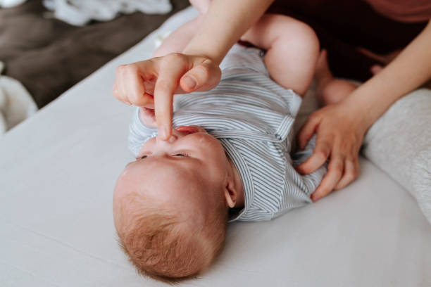 istock Mother applying baby cream on her baby 1451407123