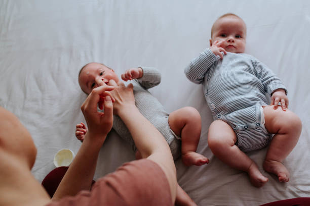 istock Mother applying baby cream on her babies 1451407151