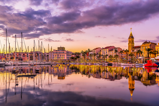 Scenic view of the small port of Sanary sur Mer in south of France after winter colorful sunset and illuminated by Christmas lights