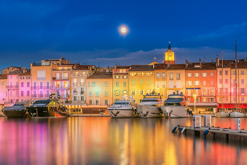 Scenic view of Christmas colorful illuminated Saint Tropez against full moon