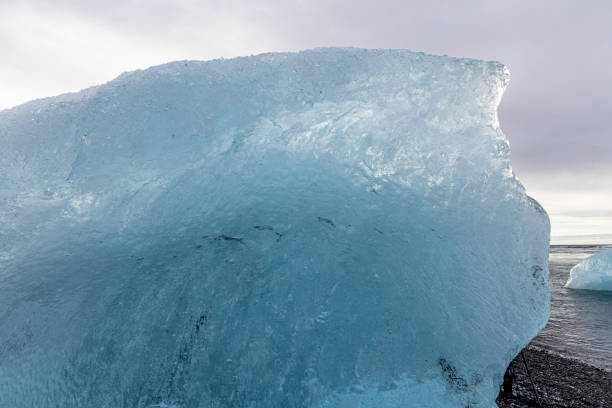 Diamond Beach is a strip of black sand belonging to the greater Breiðamerkursandur glacial plain, located by Jökulsárlón glacier lagoon on the South Coast of Iceland. The icebergs which fill the Jökulsárlón glacier lagoon wash up on shore, creating a stark contrast with the volcanic black sand.