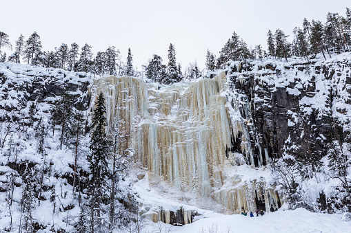 waterfall with yellow color in the hills of lapland