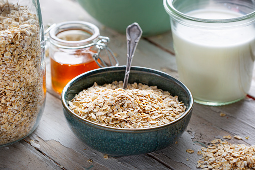 Rolled oats, milk, honey and bowl