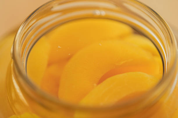 istock Canned Yellow Peaches Macrophotography 1451422274
