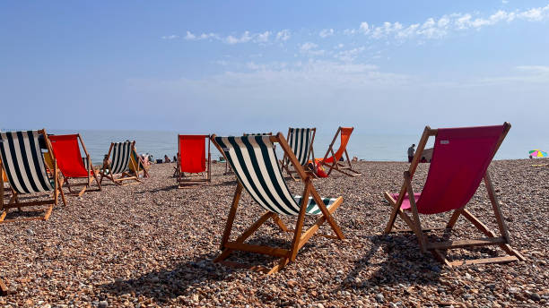 istock Traditional Deckchairs on a Pebble Beach at St Leonards on Sea, England 1451423823