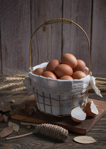 istock Chicken eggs in gift basket on wood table. 1451424675