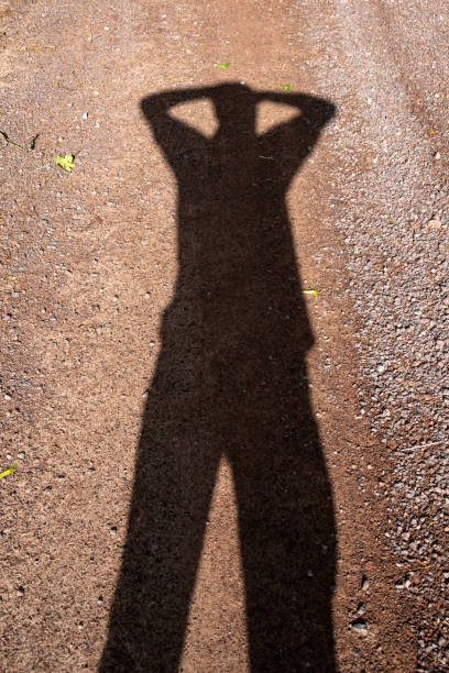 Silhouette of a man clasping his hands over his head. High quality photo