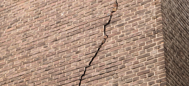 Repeating pattern of bricks in a wall with holes