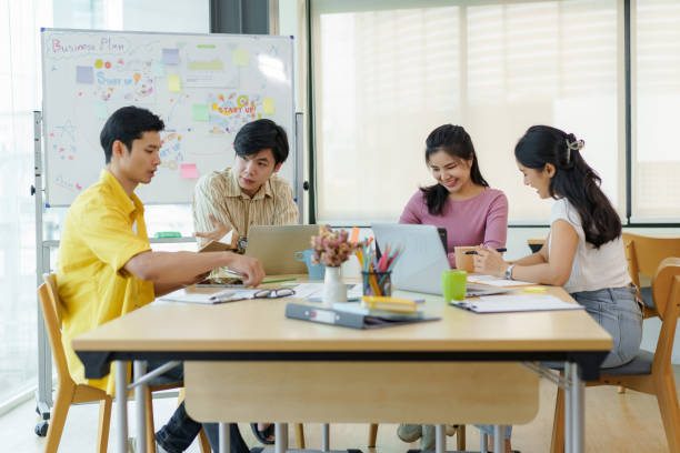 istock Group Young Asian business people with the creative work, talk and exchange ideas shared at the meeting. 1451430677