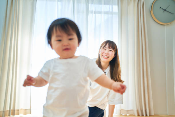 istock Parent and child playing in the room 1451430811