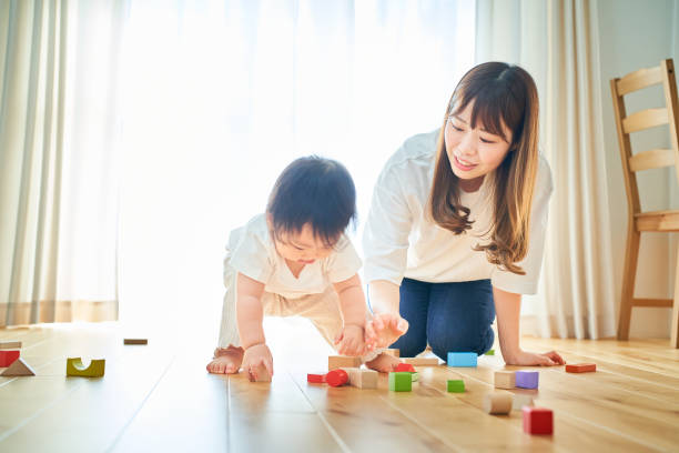 istock Mother and child playing with building blocks 1451432362