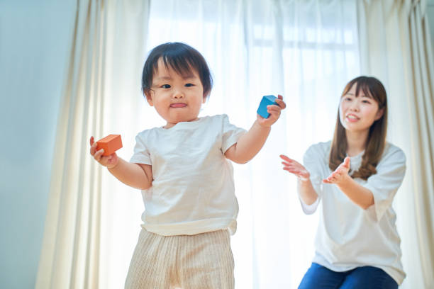istock Mother and child playing with building blocks 1451433372