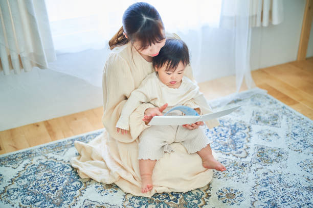 istock Parent and child reading a picture book 1451433529