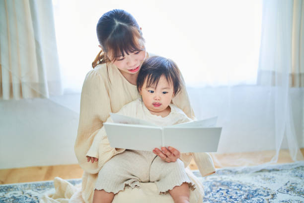 istock Parent and child reading a picture book 1451433701