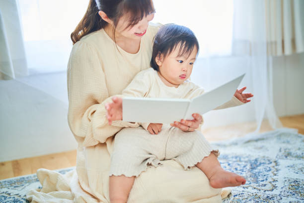 istock Parent and child reading a picture book 1451433820