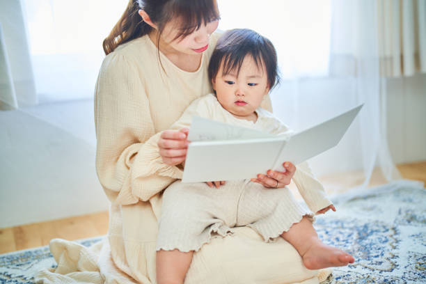 istock Parent and child reading a picture book 1451433895
